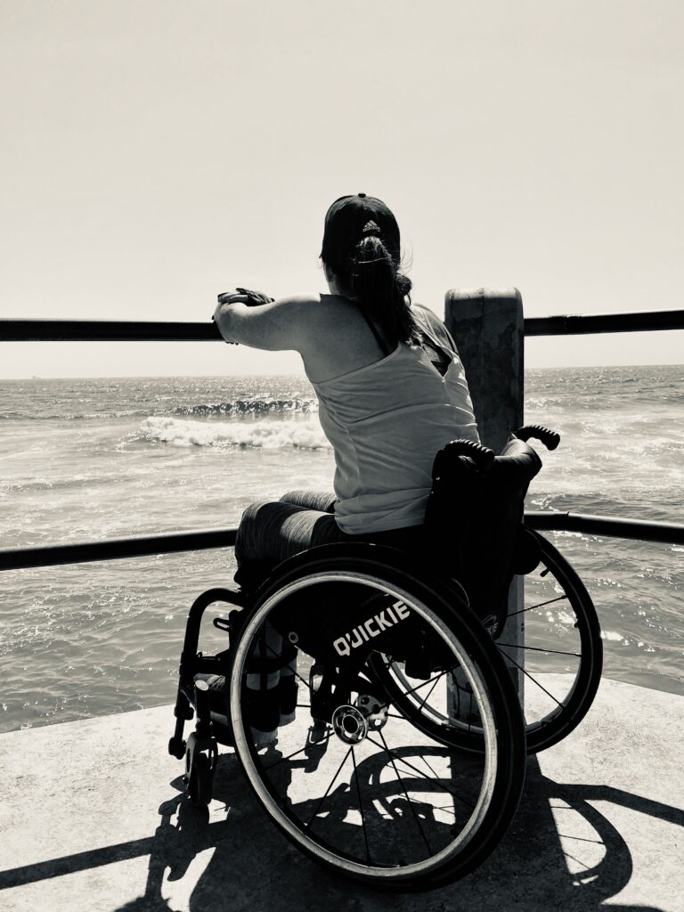 wheeelchair person gazing out at ocean